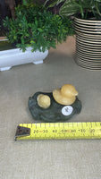 Orange calcite duck on a green jade Lily pad