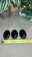 Obsidian palm stones