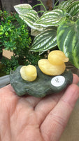 Orange calcite duck on a green jade Lily pad