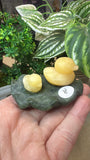 Orange calcite duck on a green jade Lily pad