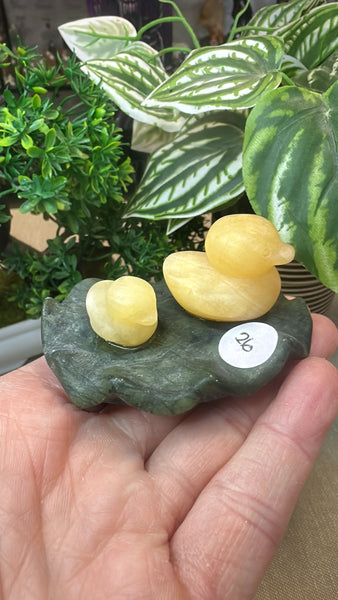 Orange calcite duck on a green jade Lily pad