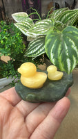 Orange calcite duck on a green jade Lily pad